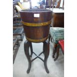 A coopered oak jardiniere on stand, makers mark, R.A. Lister,Dursley