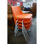 A set of four Robin Day orange chairs by Hille
