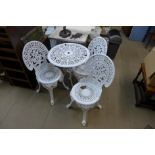 A vintage cast iron circular garden table and three chairs, a/f