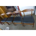 A set of four teak and vinyl dining chairs