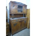 An early 20th century French carved oak and marble topped dresser