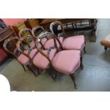 A set of six Victorian carved walnut and upholstered balloon back dining chairs