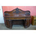 A Victorian carved mahogany pedestal sideboard