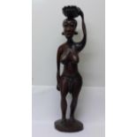 An African carved figure of a lady, 66cm