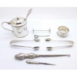 Five silver items, two pairs of sugar bows, knife rest, napkin ring and a salt spoon, 70g, a