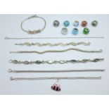 A collection of seven bracelets and eight charm beads