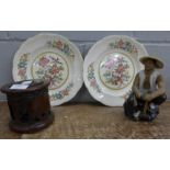 A pair of plates, an oriental figure and a set of carved coasters