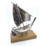 A white metal model boat on stand, height 19cm