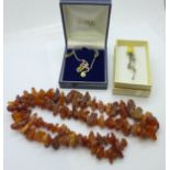 A Baltic amber necklace, a silver and amber jewellery set and a silver and amber rose brooch