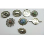 A collection of silver and white metal brooches including a memorial brooch hallmarked Birmingham