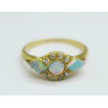 A yellow metal, opal and diamond ring, mark worn, tests as 18ct gold, 2.2g, M