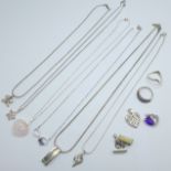 A collection of jewellery including six silver pendants on chains, two other pendants, two rings and
