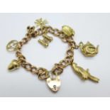 A 9ct gold charm bracelet with seven hallmarked 9ct gold charms and one 18ct gold filigree cross