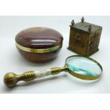 A money box with regimental badges, a magnifying glass with mother of pearl handle and an onyx