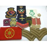 Assorted cloth uniform badges and an armband