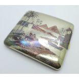 A white metal cigarette case with Egyptian Nile and pyramid scene decoration on the inside and out