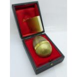 A limited edition Stuart Devlin silver gilt egg with hen and chick hatching, boxed with certificate,
