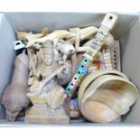 A box of tourist carvings, including the God Saraswathe, a lion, Indian elephant, etc.