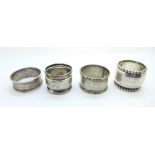 Three silver napkin rings including one Danish hammered silver napkin ring with inscription dated