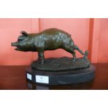 A bronze figure of a pig on a marble plinth