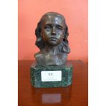 A small bronze female bust on a marble plinth