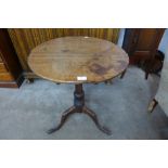 A George III circular oak tilt top tripod table