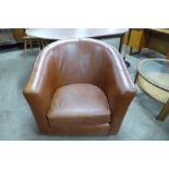 A tan leather tub chair