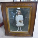 An Edward VII overpainted photograph of a young girl, framed