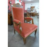 A Victorian carved oak and upholstered armchair