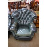 A green leather buttoned wingback armchair