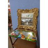 A Rococo style gilt framed mirror and a painted framed mirror