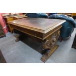 A Victorian carved oak two drawer library table