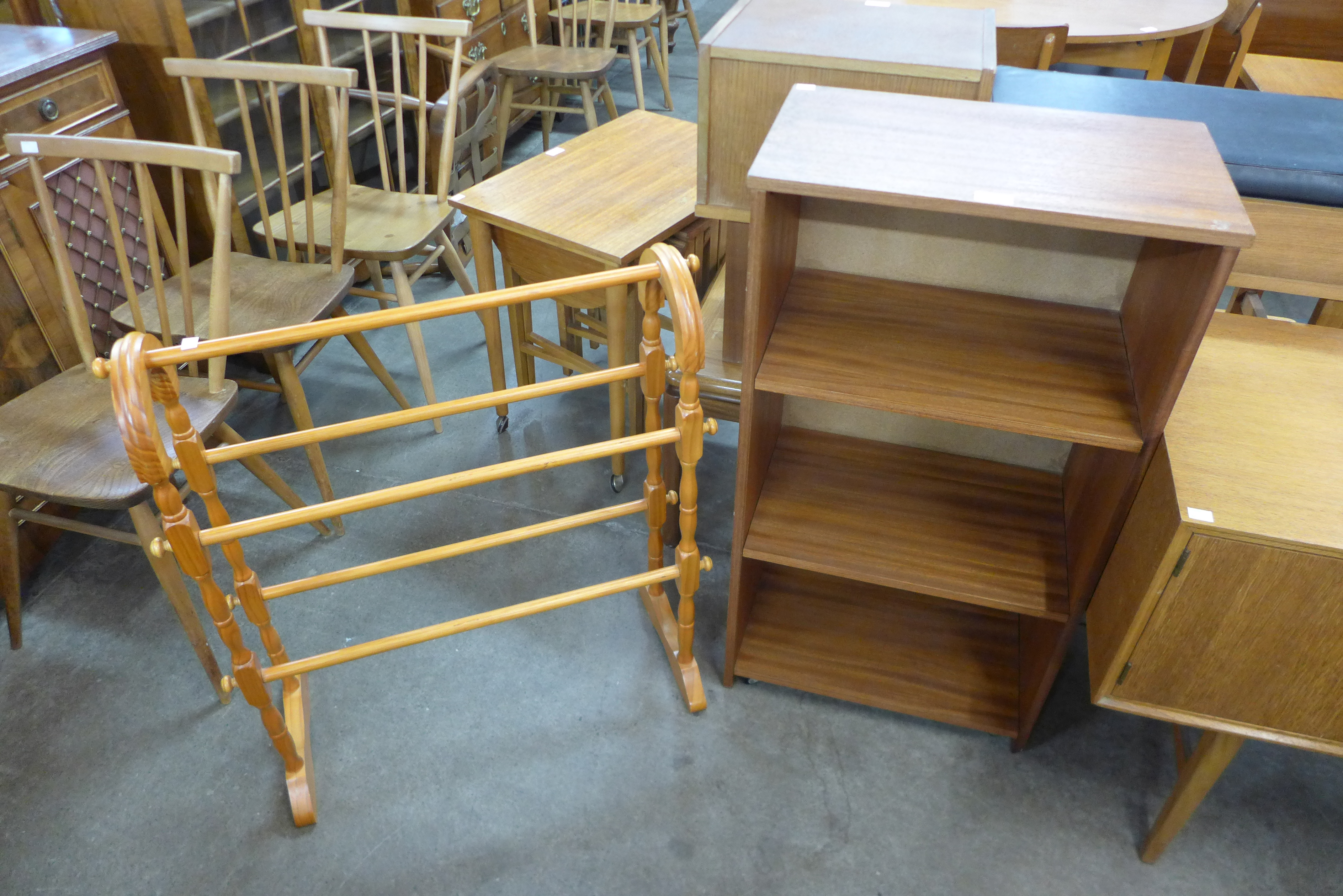 A teak open bookcase and a pine towel rail