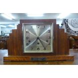 An Art Deco oak mantel clock with chiming movement and silver presentation plaque