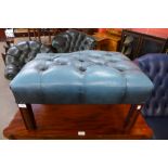 A mahogany and blue leather footstool