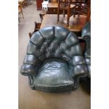 A green leather buttoned armchair