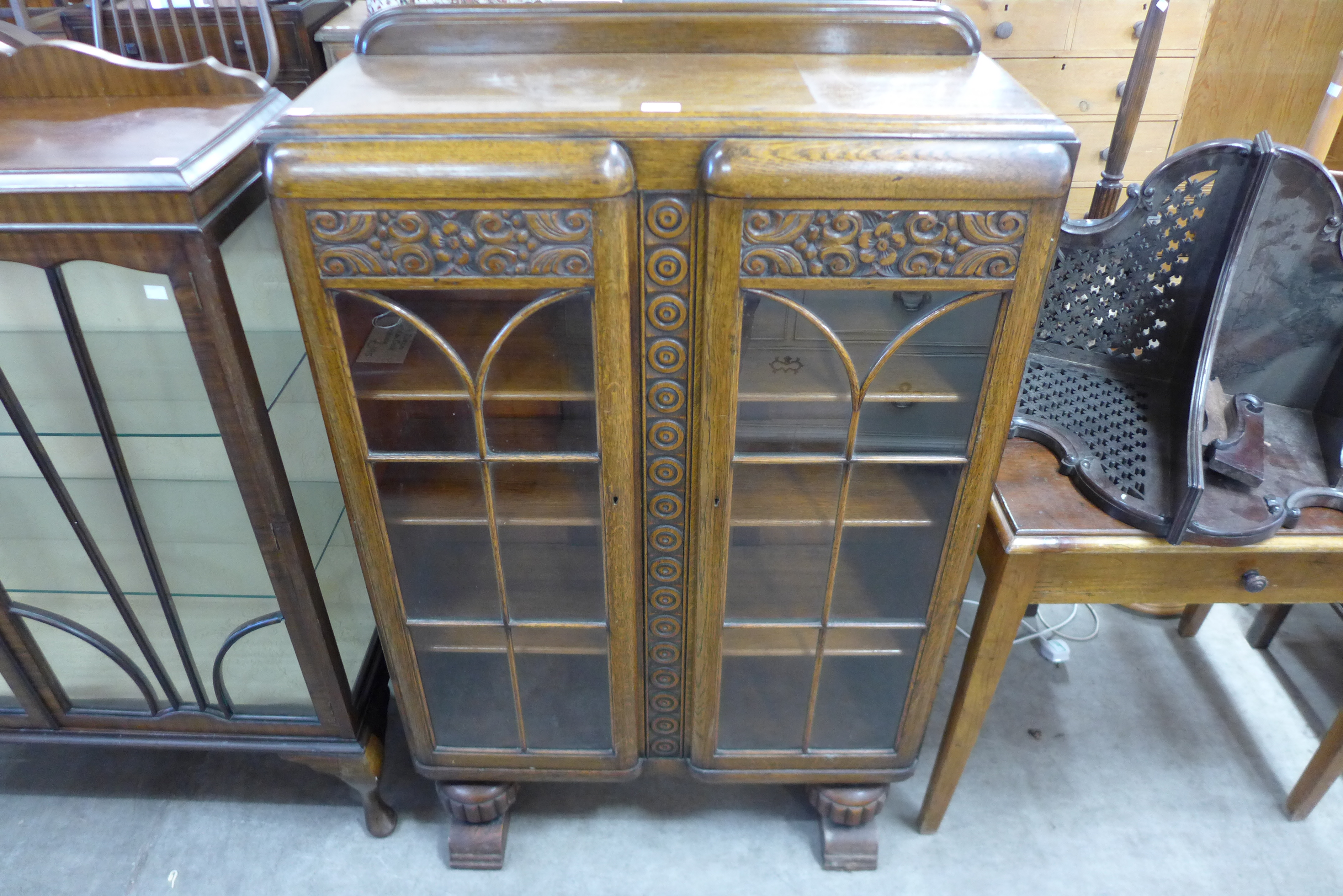 An Art Deco carved oak two door bookcase ( locked without key )