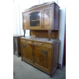 An early 20th century French carved oak and marble topped buffet sideboard