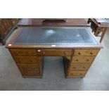 A Victorian oak and leather insert desk