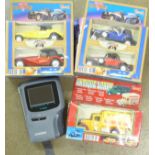 A Casio hand held Casio TV-1800 television and boxed model vehicles