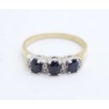 A 9ct gold ring set with eight diamonds and three sapphires, 2g, R