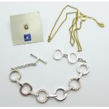 A Swarovski bracelet, neck chain and pin badge/stud