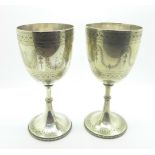A pair of silver plated engraved wine goblets