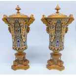 A pair of French champleve enamel and ormolu trumpet shaped vases, each with mask mounts and