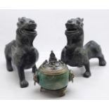A pair of metal fire dogs, and an onyx and plated metal pot, the lid decorated with three frogs