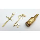 Two 9ct gold charms and a 9ct gold cross pendant, Guinness bottle charm dented, 2.9g
