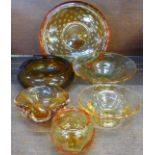 Six items of amber coloured glass with controlled bubbles