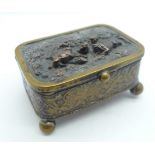 A metal and silk lined jewellery casket with hunting scene on lid, mark FC on base, 6.5cm x 4.5cm