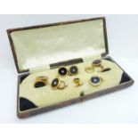 A cased set of buttons and cufflinks