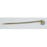 A yellow metal set diamond stick pin, approximately 0.4carat weight